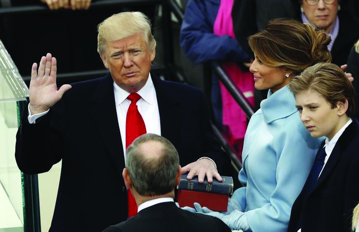US President Donald Trump takes the oath of office with his wife Melania and son Barron at his side, during his inauguration at the U.S. Capitol in Washington, U.S., January 20, 2017. REUTERS/Kevin Lamarque