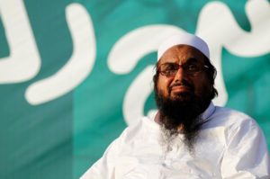 Hafiz Muhammad Saeed, chief of the banned Islamic charity Jamat-ud-Dawa, looks over the crowed as they end a "Kashmir Caravan" from Lahore with a protest in Islamabad, Pakistan July 20, 2016. REUTERS/Caren Firouz/Files