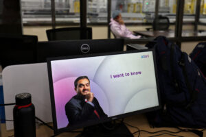 FILE PHOTO: A technician talks on his cell phone at the Photovoltaic Modules assembling plant of Adani Green Energy Ltd (AGEL), in Mundra, India, April 11, 2024. REUTERS/Amit Dave/File Photo