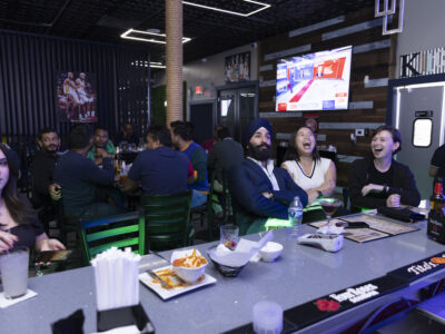 People gather at Rang Sip & Dine, a restaurant and bar in Suwanee, Georgia, to watch Tuesday night's election results. (Kendrick Brinson for The Washington Post)